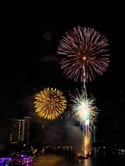 Fireworks over Chaopraya river near hotel in Bangkok Thailand