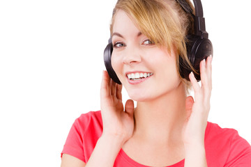 Naklejka premium Woman in big headphones listening music isolated