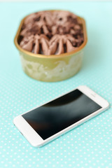 Top view of smart phone chocolate ice cream, table background. 