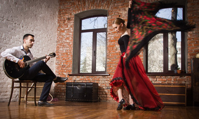 Young woman dancing flamenco and a man playing the guitar - obrazy, fototapety, plakaty