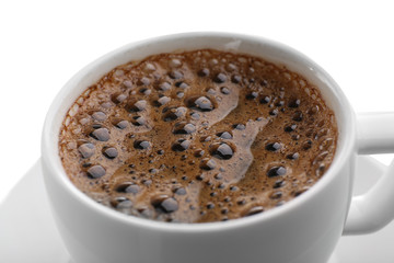 Cup of coffee with brown foam isolated on white, close up