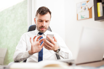 Businessman reading emails on his smartphone