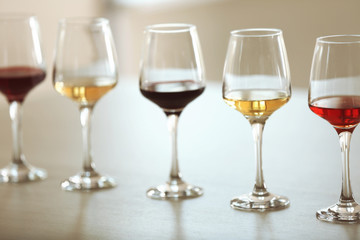 Many glasses of different wine in a row on a table