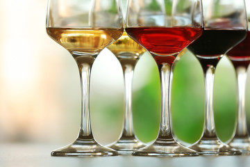 Many glasses of different wine in a row on a table