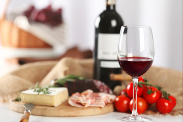 Glass of wine with food on table closeup
