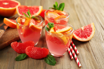 Ripe grapefruits and fresh juice with mint, close up