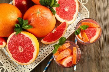 Ripe grapefruits and fresh juice with mint, close up