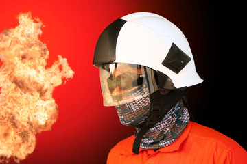 Fototapeta premium Fire fighter on oil and gas industry, successful firefighter at work , Fire suit for fighter with fire and suit for protect fire fighter, Security team when fire case.