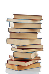 Stack of new and old books isolated on white