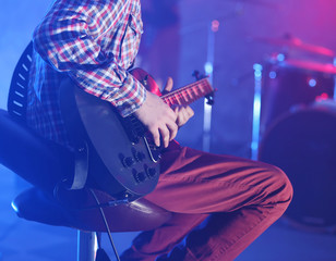 Fototapeta premium Man playing electric guitar on stage.