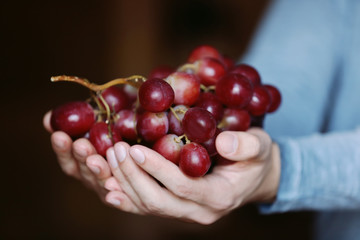 Man holding big bunch of grapes