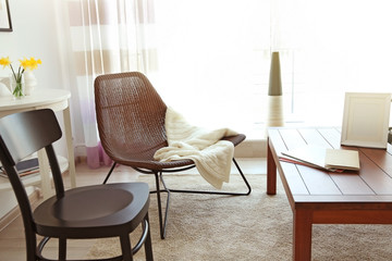 Modern living room interior. Different kinds of chair around table.