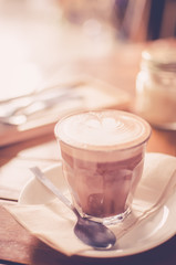 Coffee on wood table background. Shallow dept of field. Drink background concept.