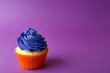 Birthday cupcake on purple background