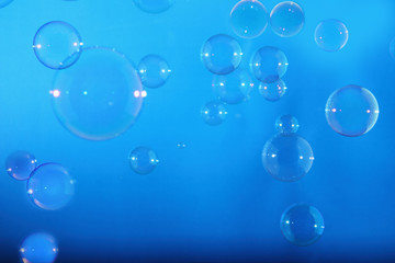 Rainbow soap bubbles on a blue backgrounds