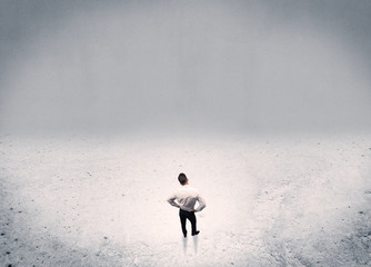 Businessman standing in urban empty space