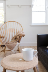 Fototapeta na wymiar Focus on cup of tea in contemporary styled living room