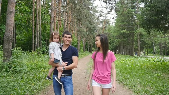 Happy Family on the Walk in Forest