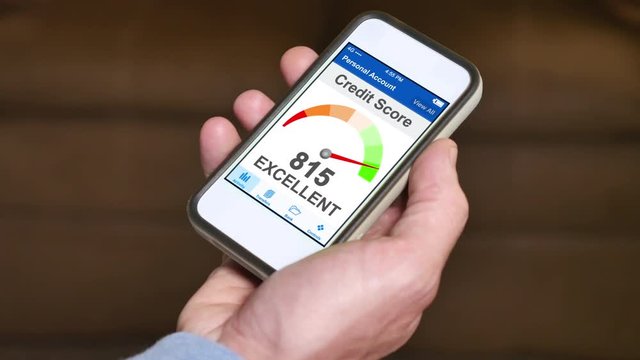 A man checks his FICO credit score on his smartphone. The result is excellent. Fictional device and screen interface.	