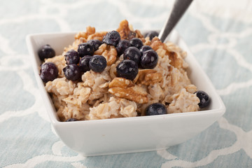 Oatmeal with chia seeds, brown sugar, blueberries, walnuts, and milk