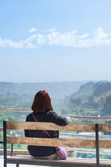 Traveler woman sits on chair at viewpoint for enjoy very beautif