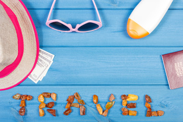 Word travel, sunglasses, straw hat, sun lotion, passport and currencies dollar, copy space for text