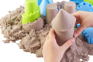 Fun kinetic sand.Child building sand castle