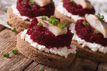 Fast sandwiches with herring, beetroot and cream cheese close-up. Horizontal
