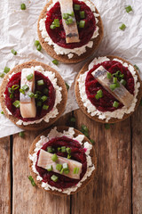 Norwegian sandwiches with herring, beetroot and cream cheese. vertical top view
