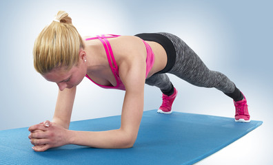 Athlete girl doing plank exercise.