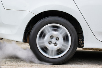 White car wheel drifting and smoking on track dark edition