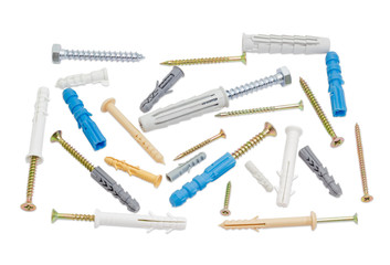 Different wall plugs and chipboard screws on light background