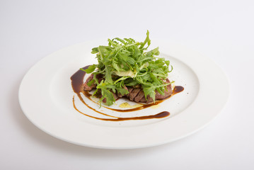 Fried meat with arugula salad