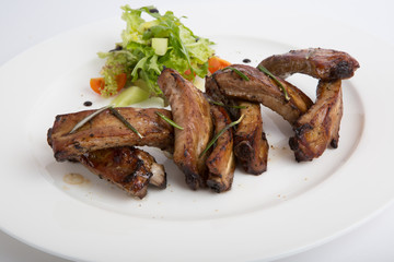 Fried ribs with salad