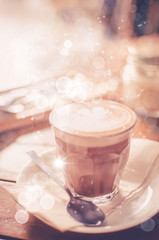 Coffee on wood table background. Shallow dept of field. Drink background concept.