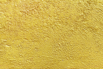 Abstract background texture cement wall in yellow gold tone. 