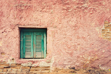 Old building detail with window and grunge red wall. Vintage background