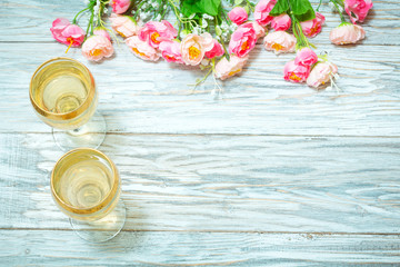 Two glasses of white wine and flowers