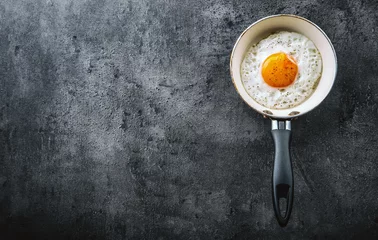 Wall murals Fried eggs Egg. Fried egg. Chicken egg. Close up view of the fried egg on a frying pan. Salted and spiced fried egg