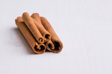 cinnamon sticks on white table