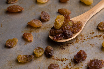 raisins on wooden spoon