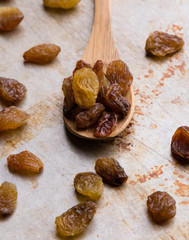 raisins on wooden spoon