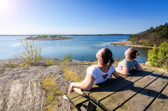 Mother and daughter sunbathing on Swedish coast