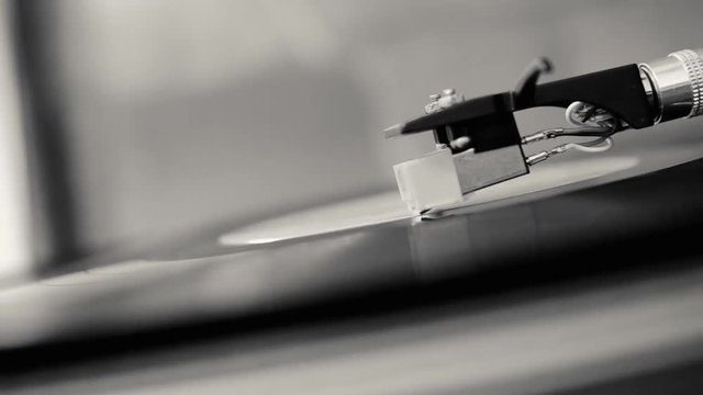 Switching off a spinning record on gramophone - Close up