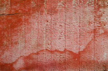 Red wooden board unevenly painted