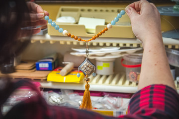 woman holding hand crafted necklace