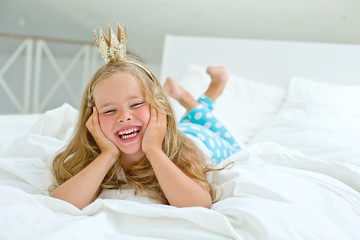 Happy kid in the morning bed 