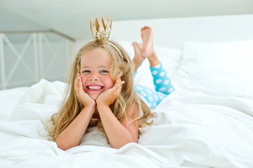 Happy kid in the morning bed 