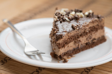 Slice of chocolate cake  garnished with nuts