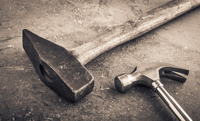 Hammer still life. Two hammers side by side on a stone workbench. Symbol of strength and force. Concept of industrial work tool, carpentry equipment and DIY object. - 111233858